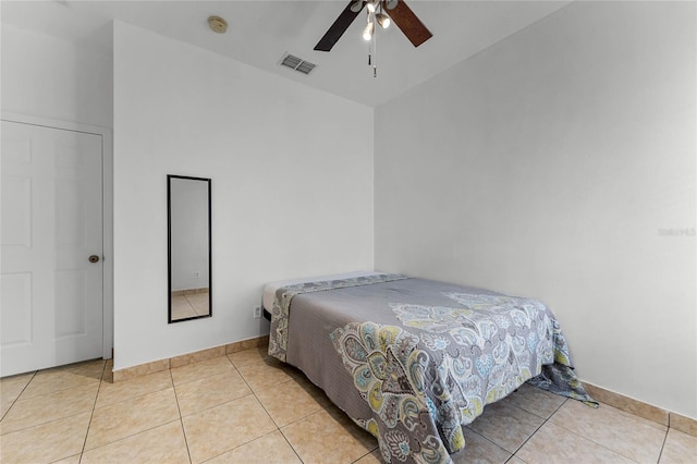 tiled bedroom with ceiling fan