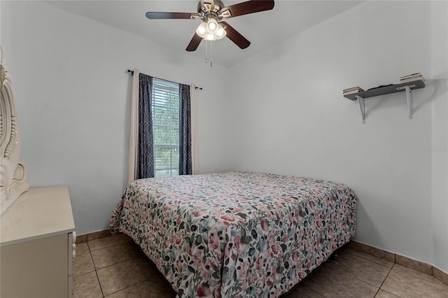 bedroom with ceiling fan and light tile patterned floors