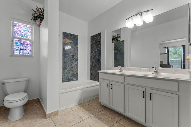 bathroom with tile patterned flooring, vanity, toilet, and a bathtub