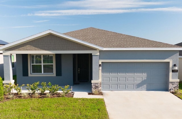 view of front facade featuring a front lawn, covered porch, and a garage