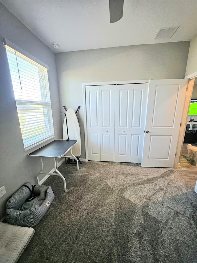 miscellaneous room with ceiling fan and carpet floors