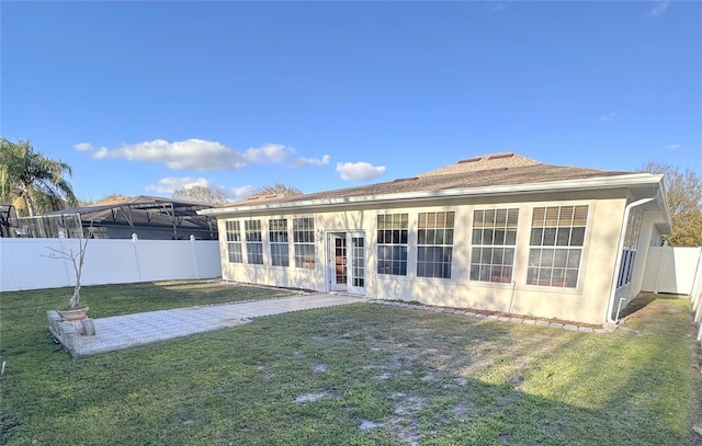 rear view of house with a yard