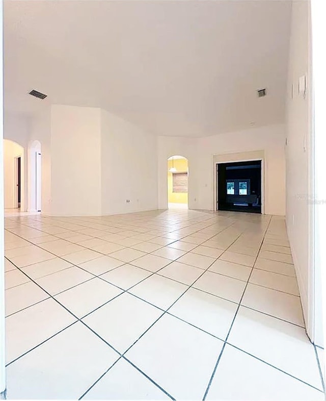 unfurnished living room featuring light tile patterned floors