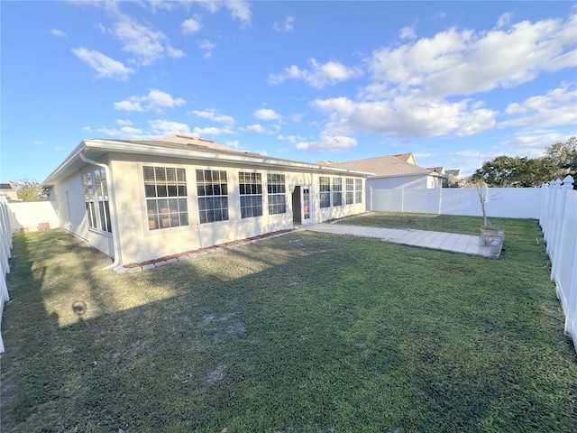 back of house featuring a yard and a patio area