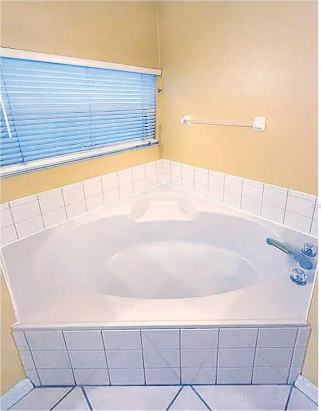 bathroom with tiled tub