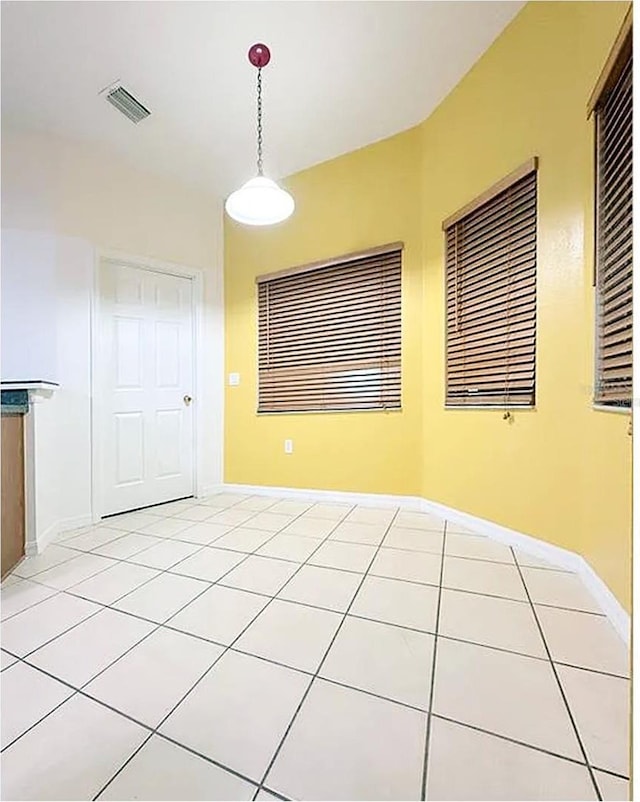 unfurnished dining area featuring light tile patterned floors