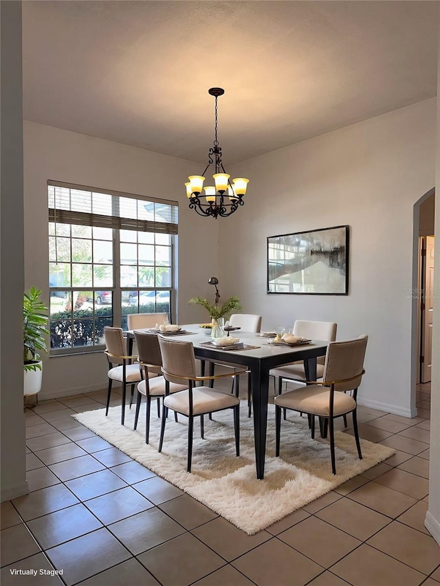 dining room featuring tile patterned flooring and a chandelier