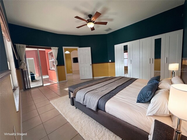 tiled bedroom featuring ceiling fan and a closet