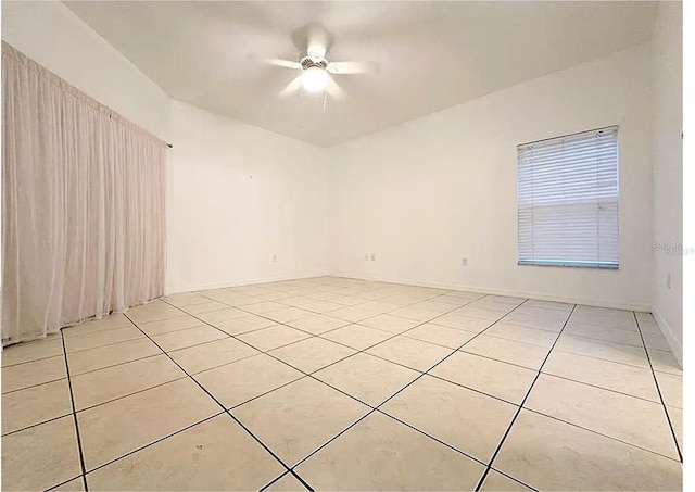 spare room with light tile patterned flooring and ceiling fan