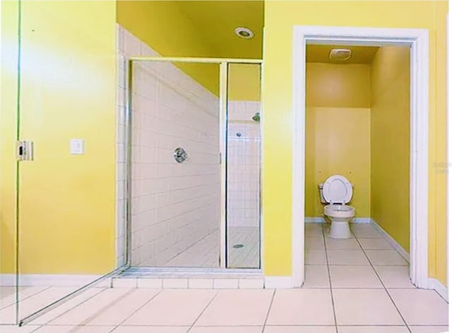 bathroom featuring tile patterned flooring and a shower with door