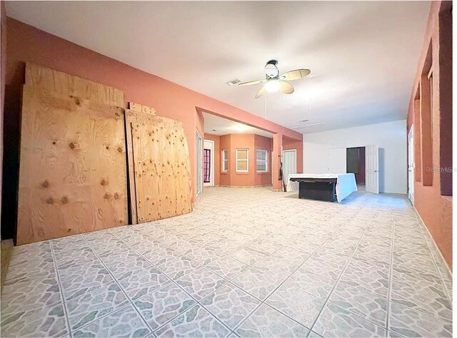 unfurnished living room with vaulted ceiling and ceiling fan