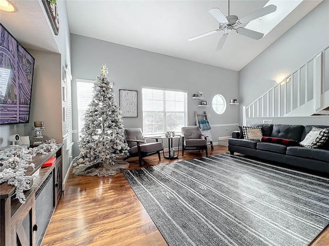 living room featuring ceiling fan, hardwood / wood-style floors, and lofted ceiling