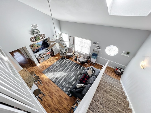 living room with hardwood / wood-style floors and high vaulted ceiling