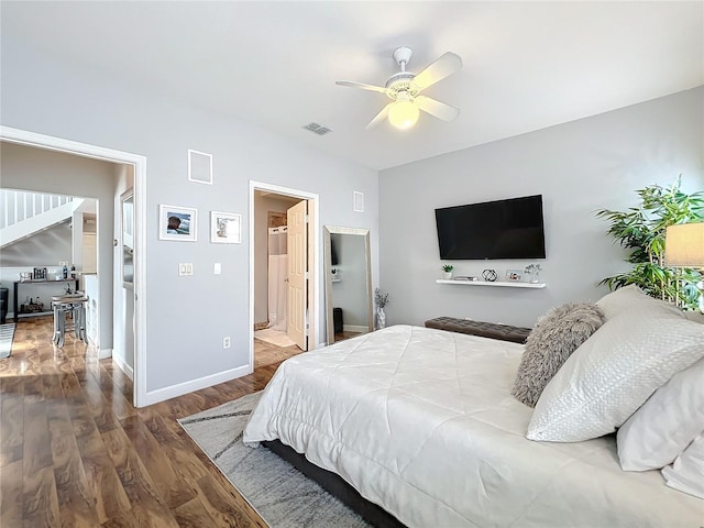 bedroom featuring wood-type flooring, ensuite bathroom, and ceiling fan