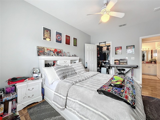 bedroom with wood-type flooring, a closet, and ceiling fan