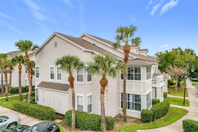 5269 Wellington Park Cir Unit 23, Orlando, FL 32839 - view of front of home with stucco siding and uncovered parking