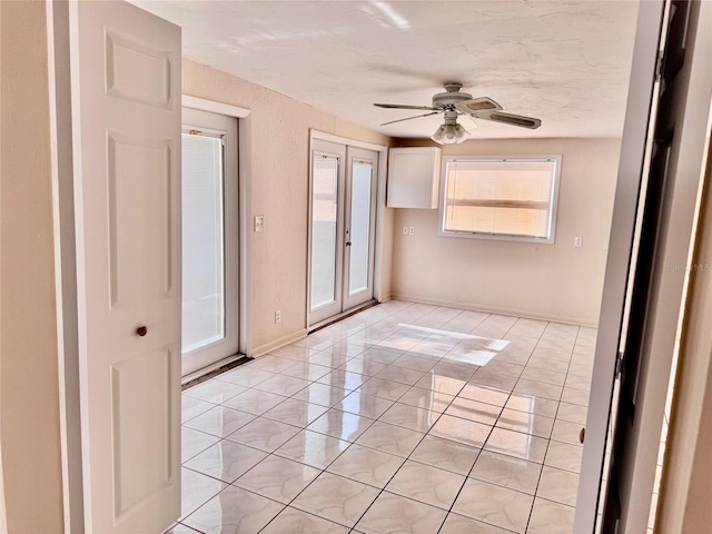 empty room with light tile patterned floors and ceiling fan