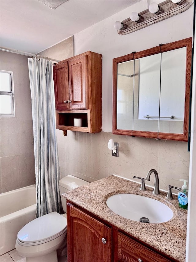 full bathroom featuring tile patterned floors, shower / tub combo with curtain, vanity, and toilet