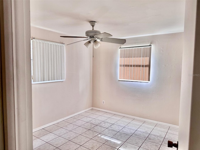 spare room featuring ceiling fan and light tile patterned floors