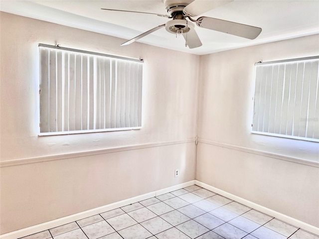 tiled spare room with ceiling fan