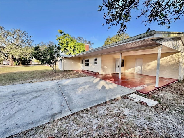 rear view of house with a yard and a patio