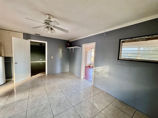 tiled spare room featuring ceiling fan