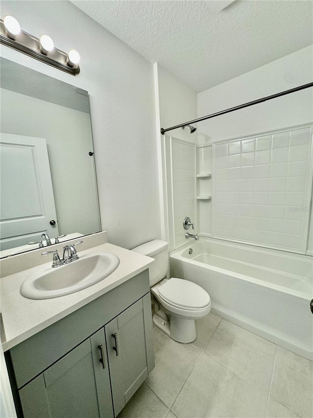 bathroom with toilet, tile patterned floors, a textured ceiling, vanity, and washtub / shower combination