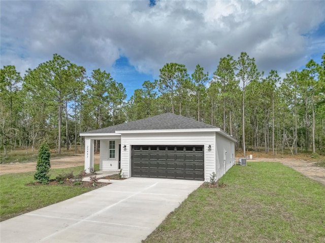 view of front of home with central AC, a front lawn, and a garage