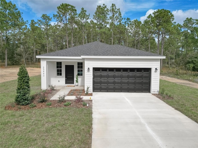 view of front of house with a front lawn and a garage