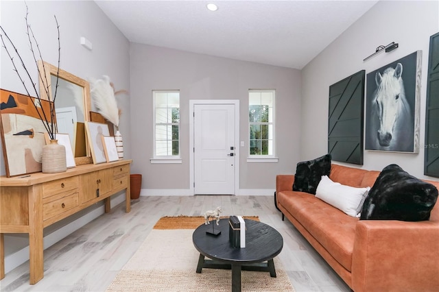 interior space with lofted ceiling and light wood-type flooring