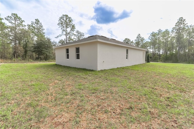 view of side of home with a lawn