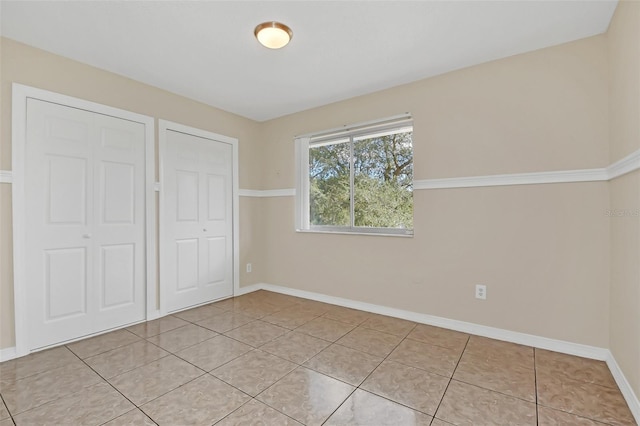 unfurnished bedroom featuring light tile patterned floors