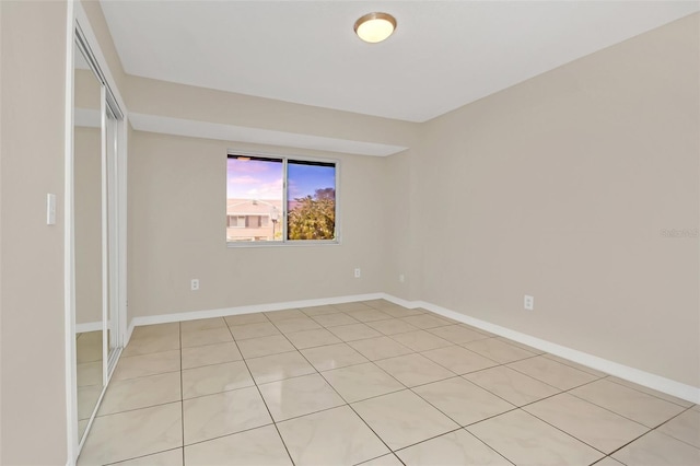 unfurnished bedroom with a closet and light tile patterned flooring