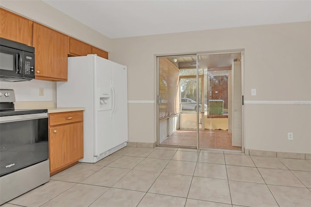 kitchen with white refrigerator with ice dispenser, light tile patterned floors, and stainless steel electric range