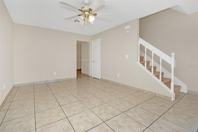 empty room featuring ceiling fan and light tile patterned floors