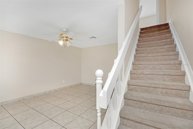 stairs with tile patterned flooring and ceiling fan