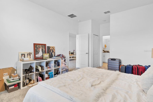 carpeted bedroom featuring connected bathroom