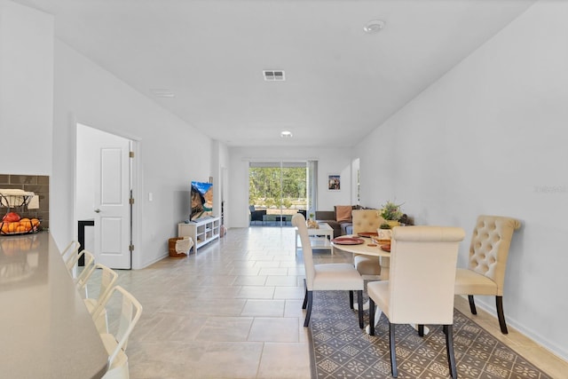 dining space featuring light tile patterned floors