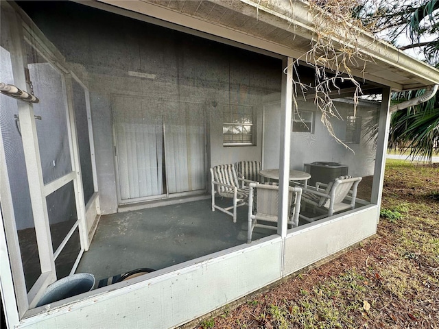 view of patio featuring a sunroom and central air condition unit