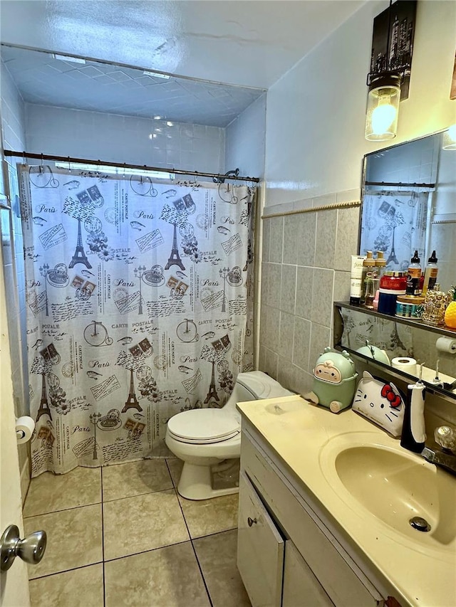 bathroom featuring toilet, tile walls, vanity, a shower with shower curtain, and tile patterned flooring