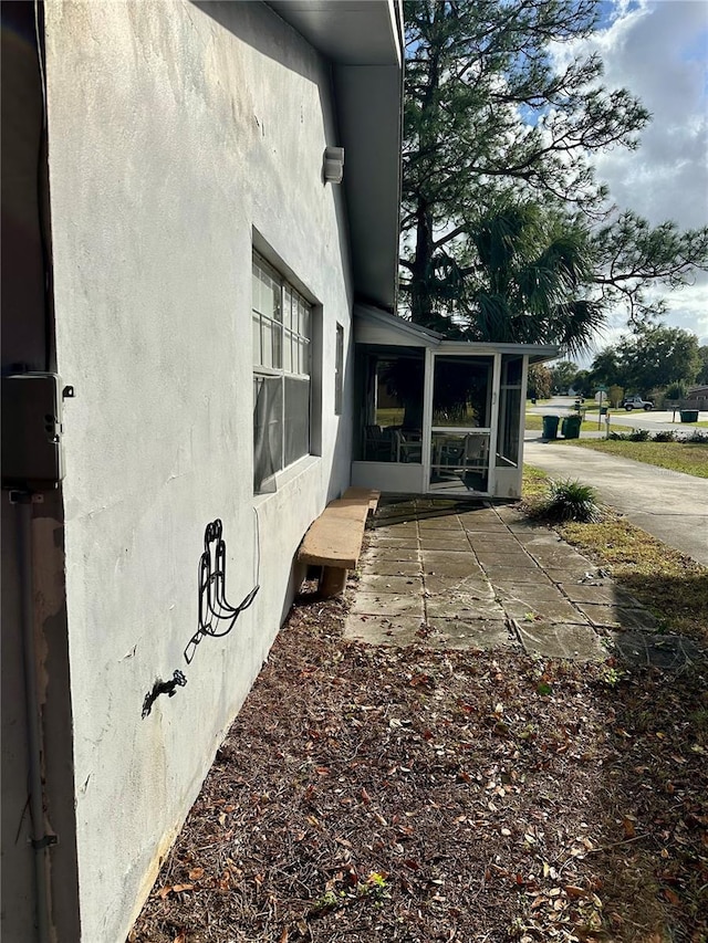 view of side of property featuring a sunroom