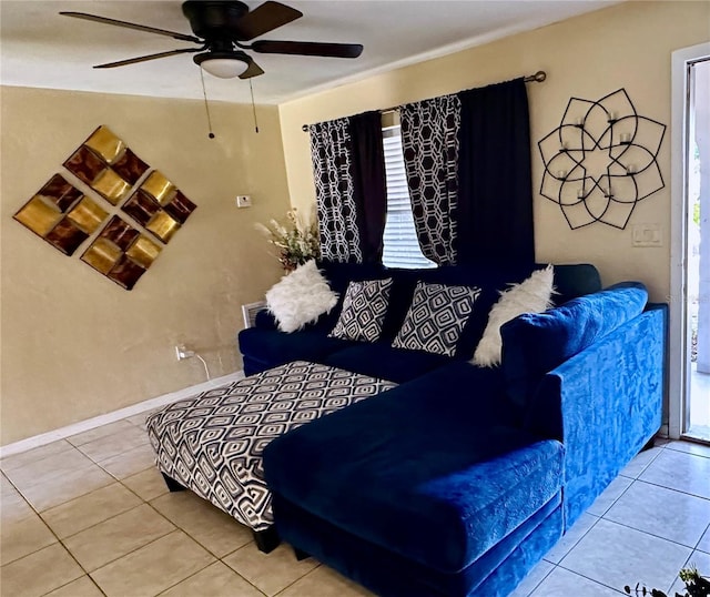 living room featuring ceiling fan and tile patterned floors