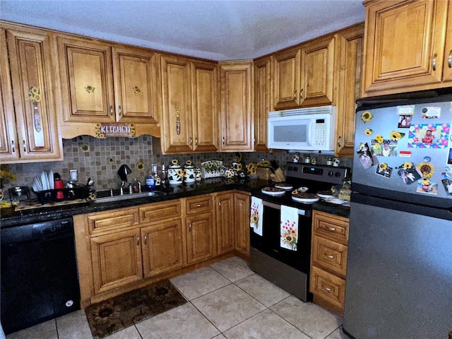 kitchen featuring stainless steel appliances, tasteful backsplash, sink, and light tile patterned floors