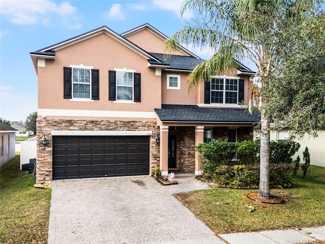 view of front of property with a front lawn and a garage