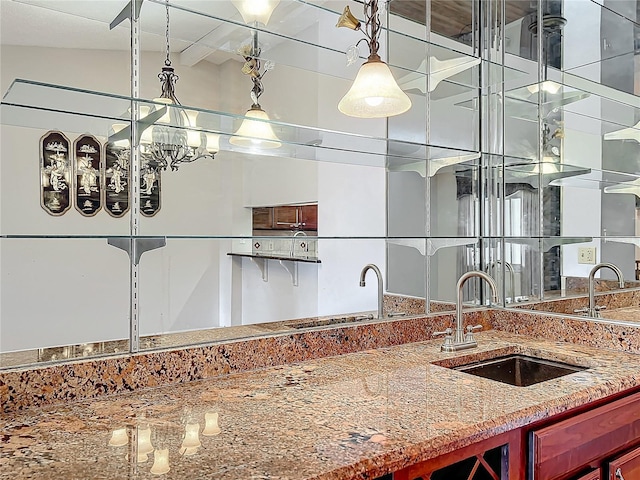 kitchen featuring vaulted ceiling and sink