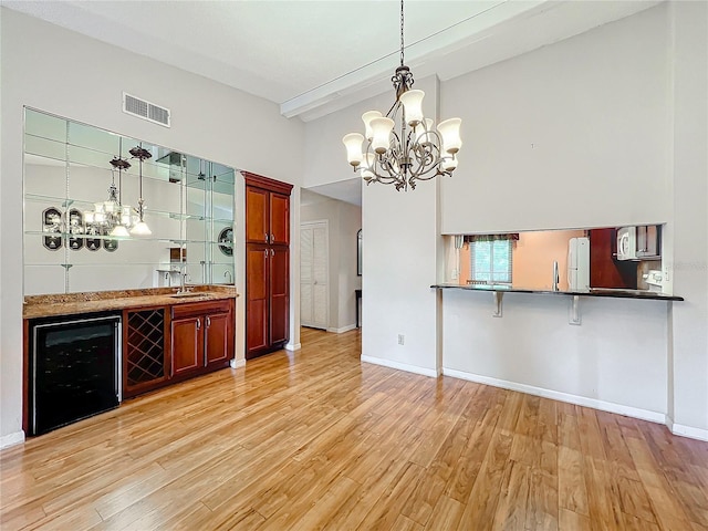 bar featuring light hardwood / wood-style flooring, wine cooler, hanging light fixtures, and sink