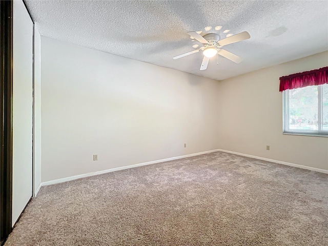 spare room featuring carpet, a textured ceiling, and ceiling fan