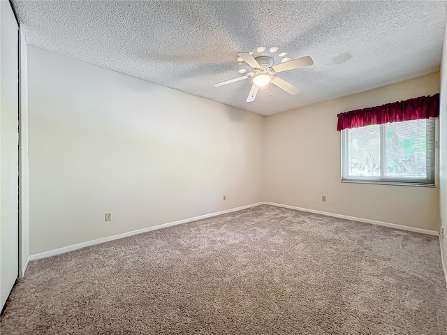 empty room featuring carpet, a textured ceiling, and ceiling fan