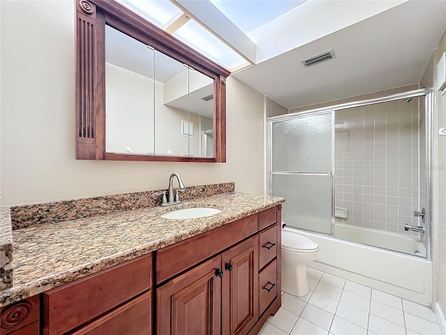 full bathroom with tile patterned flooring, vanity, toilet, and shower / bath combination with glass door