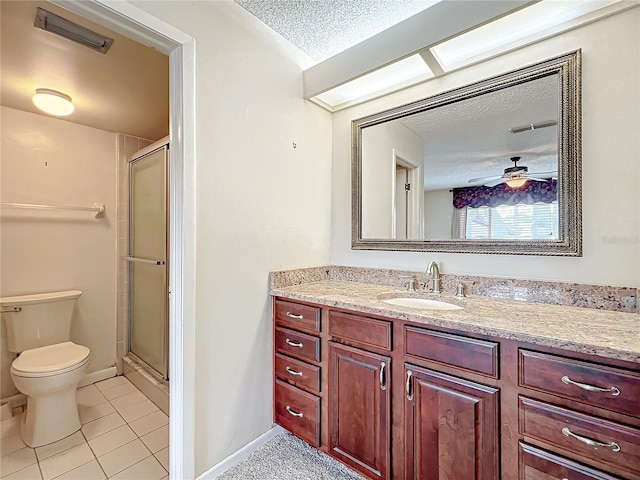 bathroom with tile patterned floors, walk in shower, vanity, a textured ceiling, and ceiling fan